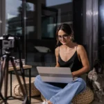 Fashion content creator working inside a realistic apartment workspace with natural lighting