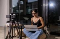 Fashion content creator working inside a realistic apartment workspace with natural lighting