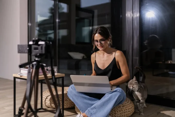 Fashion content creator working inside a realistic apartment workspace with natural lighting
