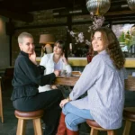 Creatives gathering inside a warm fashion-oriented café and retail environment