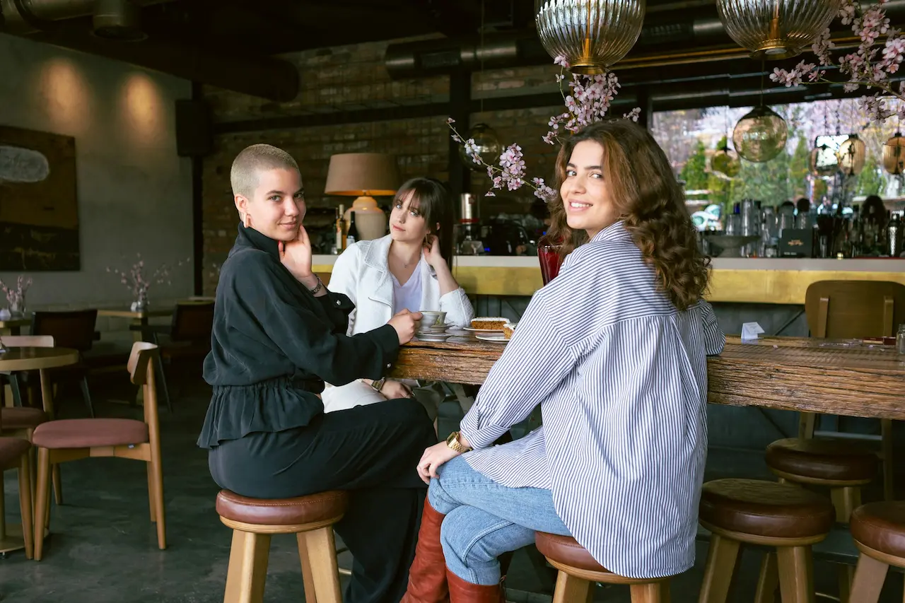 Creatives gathering inside a warm fashion-oriented café and retail environment