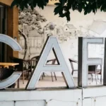 Fashion creatives discussing ideas together inside a calm café environment